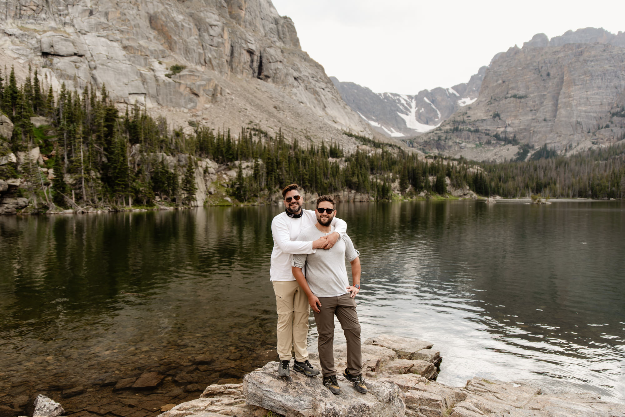 Couple taking engagement photos at a lake in Colorado